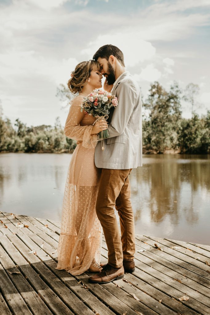 Couple holding each other on a pier