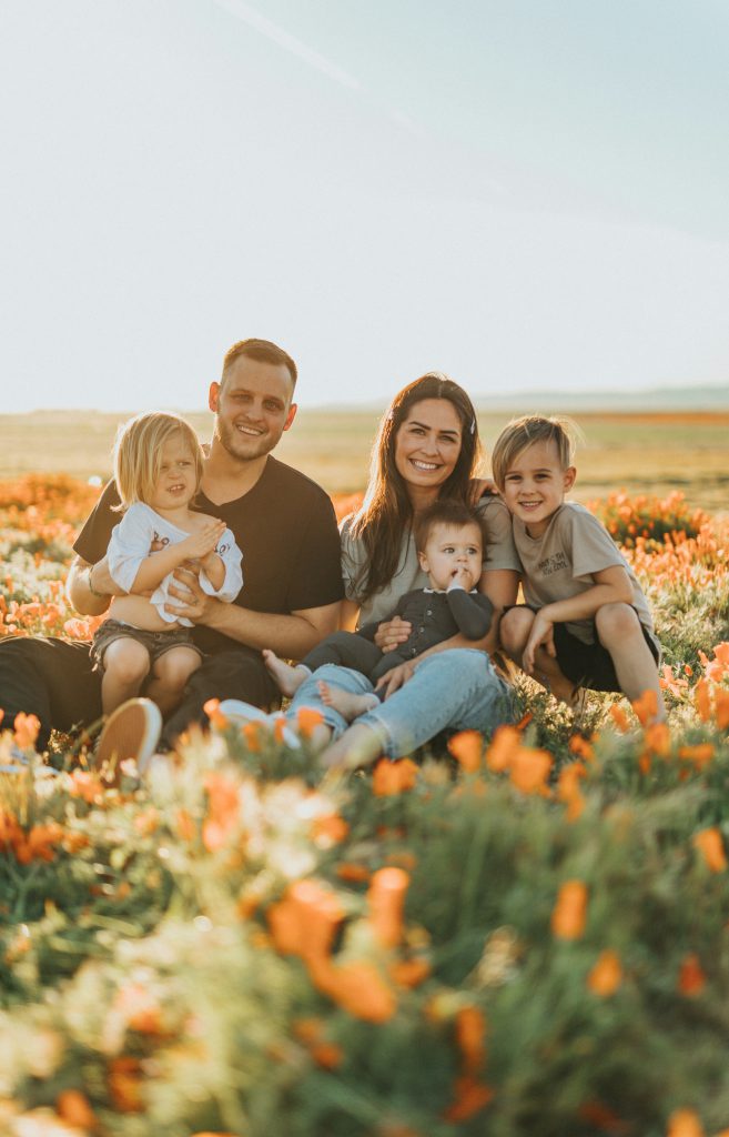 Family sitting in flower field